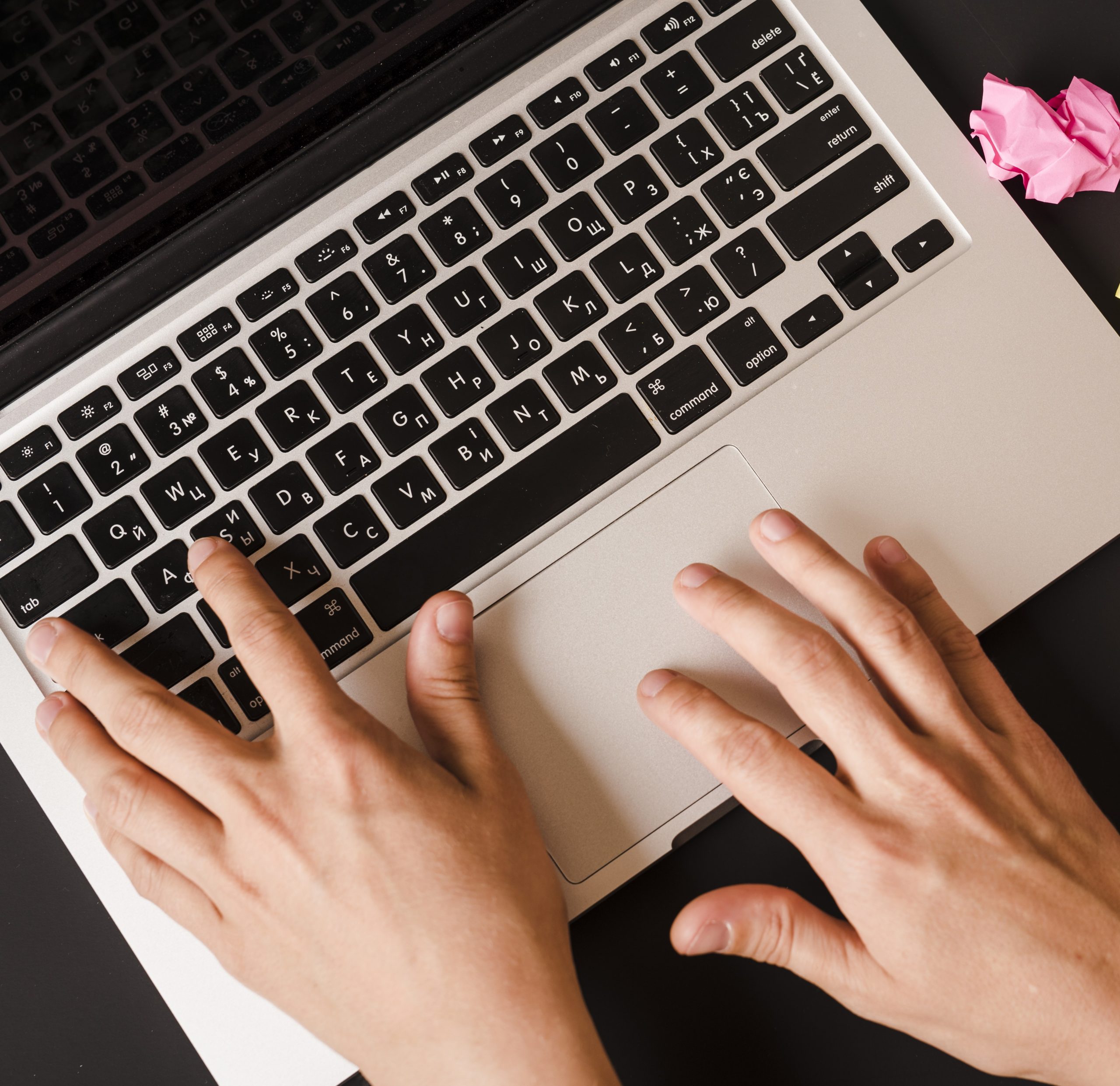 Closeup of person writing on laptop illustrates blog "Mastering Writing Skills for Project Managers"