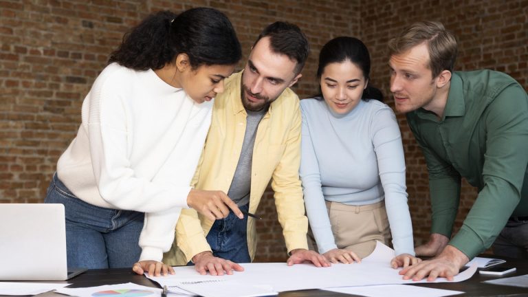 Group of four project managers working together.