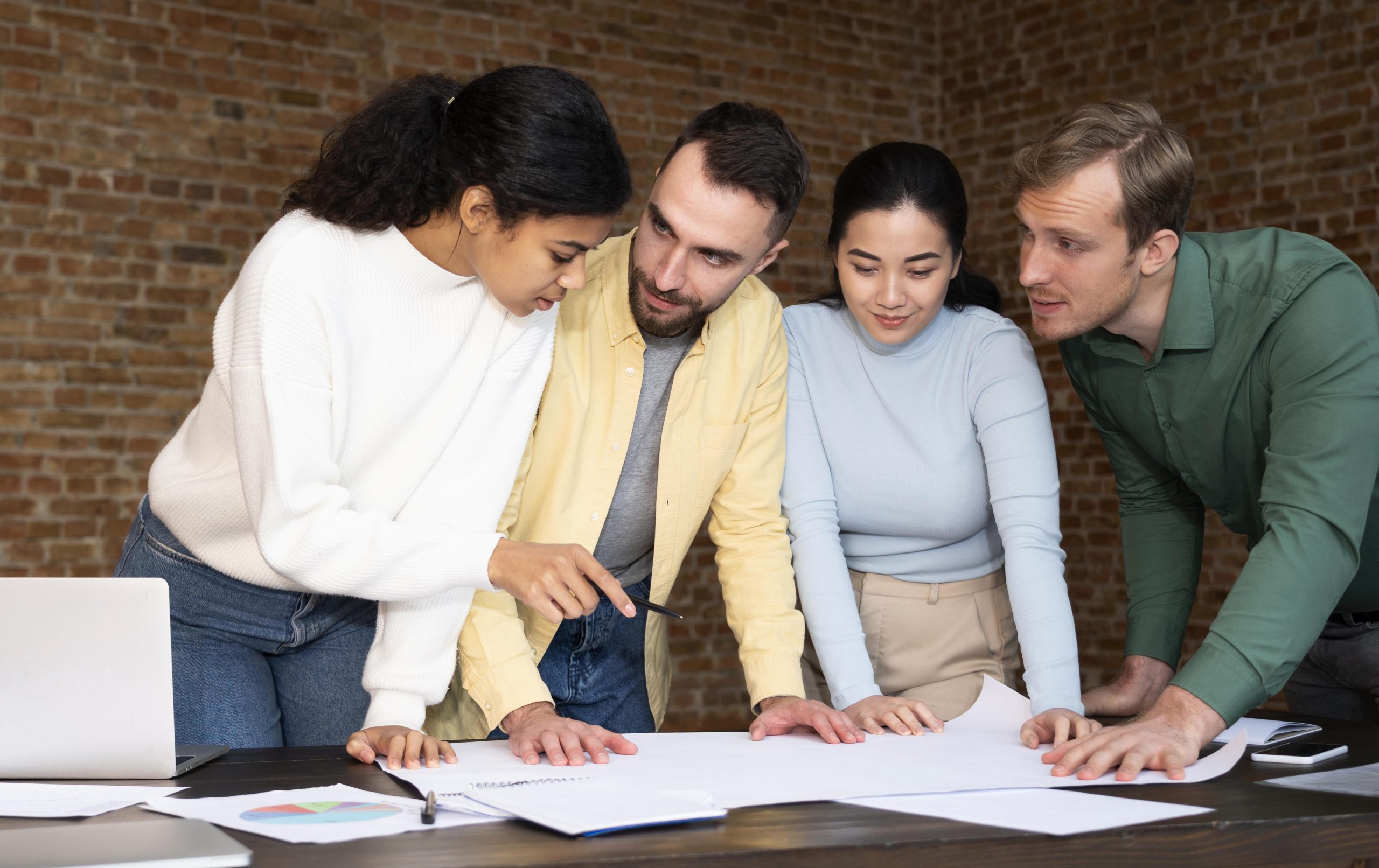 Group of four project managers working together.