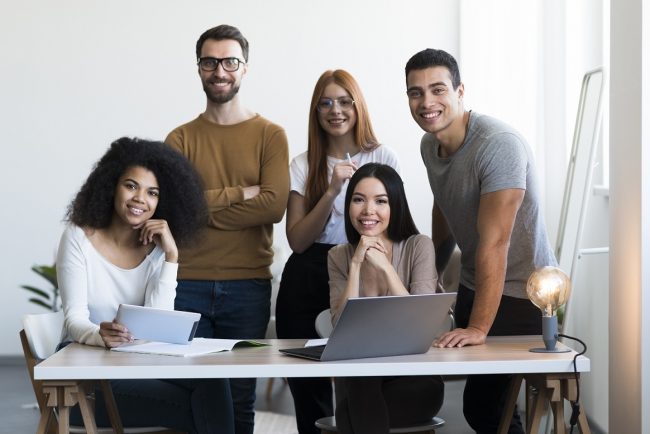 team-at-work-freepik Team at work illustrates blog "What Are Project Management Process Groups?"