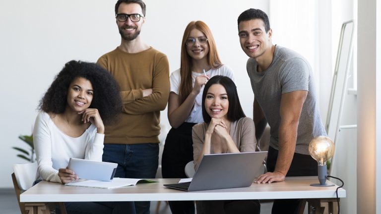 Team at work illustrates blog "What Are Project Management Process Groups?"