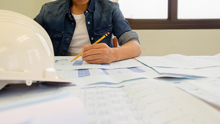Engineering design specialist reviewing blueprints in California
