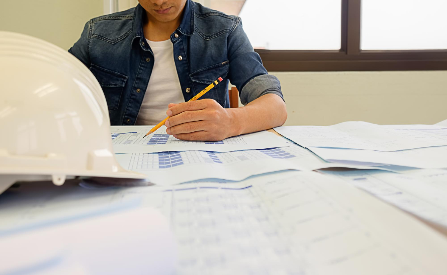 Engineering design specialist reviewing blueprints in California