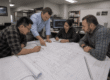 Engineers reviewing redline markups in an engineering workflow meeting