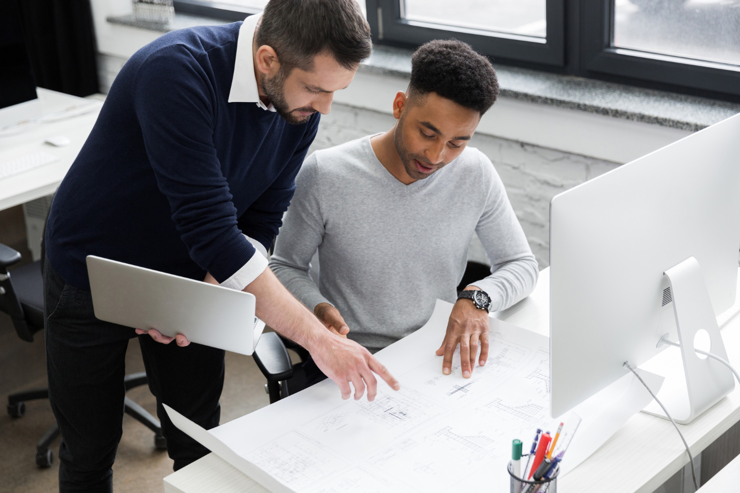 Engineering team managing design changes during project review