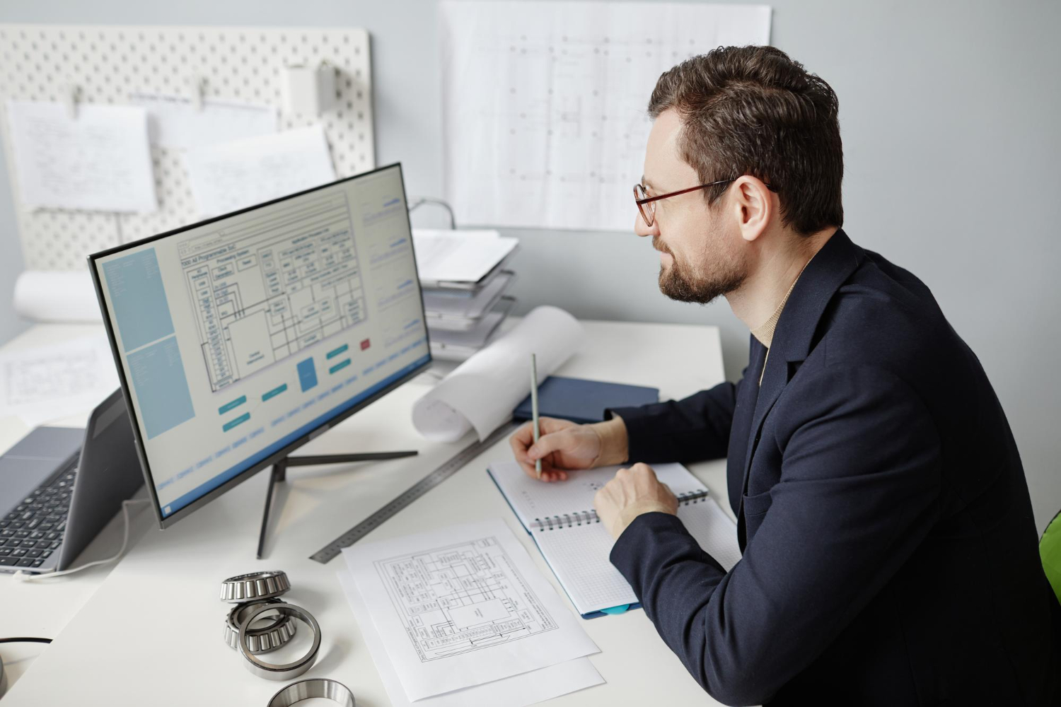 Engineer performing quality assurance drafting review on technical documents